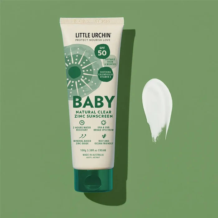 Tube of Little Urchin Baby Natural Clear Zinc Sunscreen on a green background.