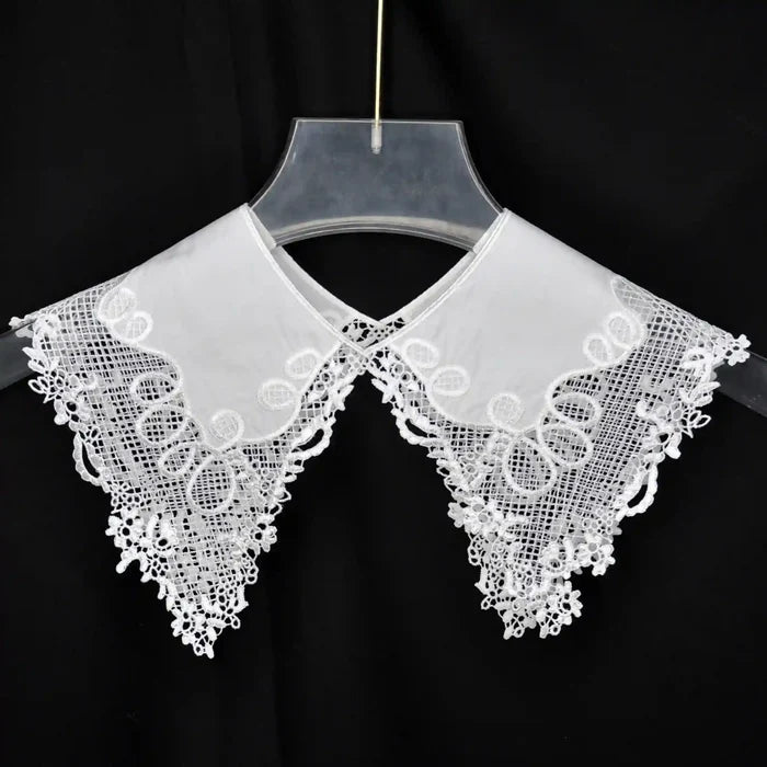 Decorative Pilgrim Flower Peter Pan collar adorned with embroidered flowers and rounded neckline shape