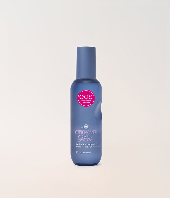 A bottle of EOS Cotton Candy body mist in a blue bottle with a matching cap, set against a plain off-white background.