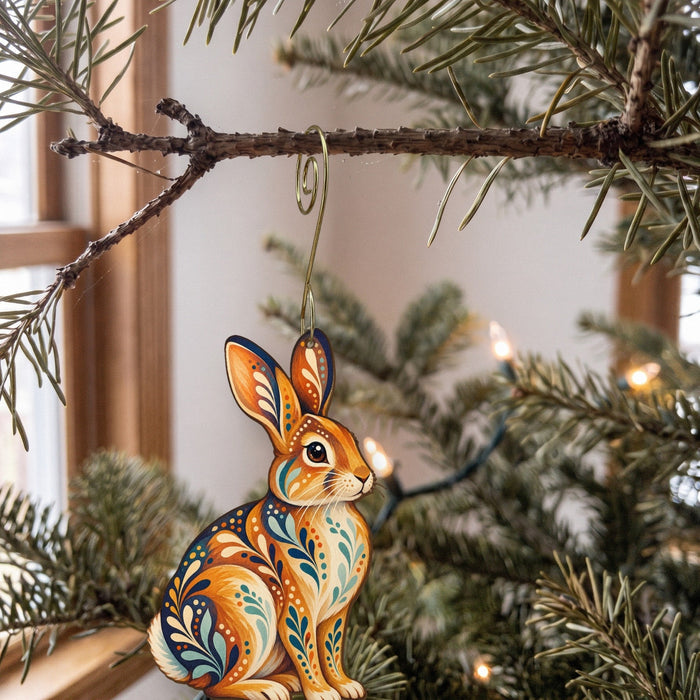 Laser-cut maple wood Eastern Cottontail folk art ornament O282 hanging on a fir branch, made in USA