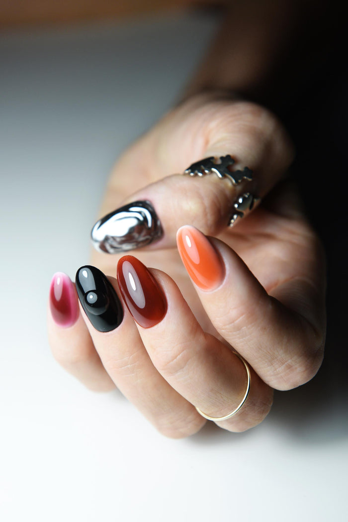 Eclectic chrome ombre press-on nails with black, silver and warm-toned details