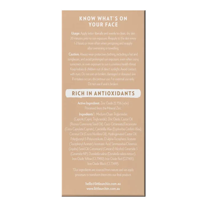 A beige product box with black text detailing the usage, caution, and ingredients of tinted sunscreen.
