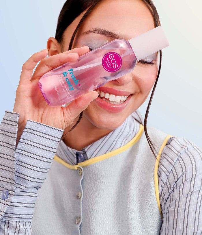 model holding eos fresh and cozy body mist