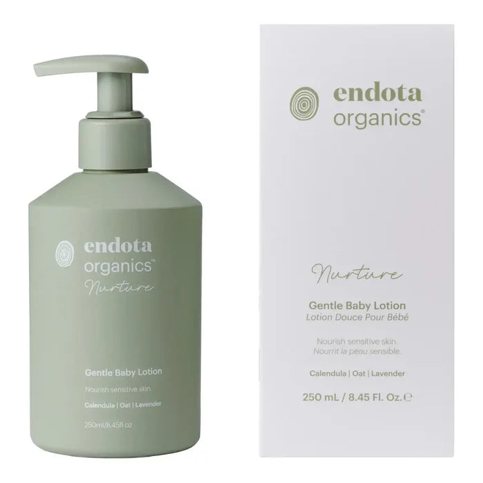 A hand holding a pump bottle of Endota Gentle Bath & Body Wash against a solid white background.