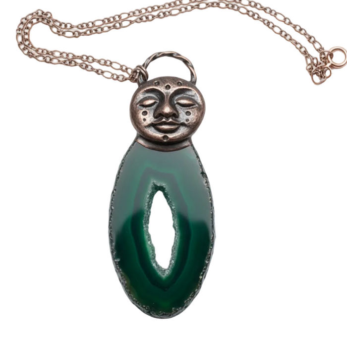 Necklace with a green pendant and copper face design on a white background