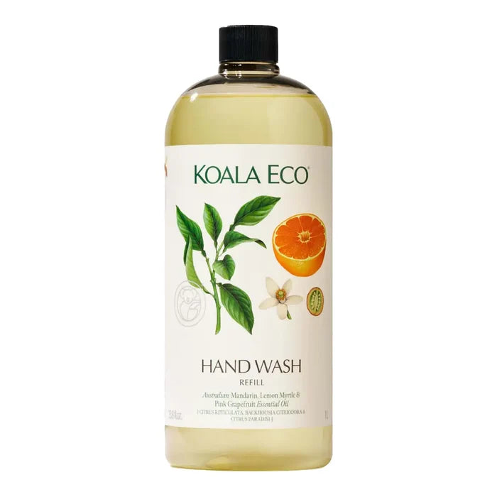 A bottle of Koala Eco Hand Wash refill with a black cap, featuring a white label with green text and illustrations of a lemon myrtle leaf, a sliced orange, and a white flower.