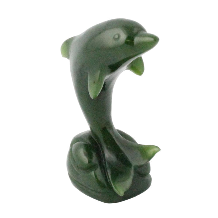Green dolphin figurine on a white background