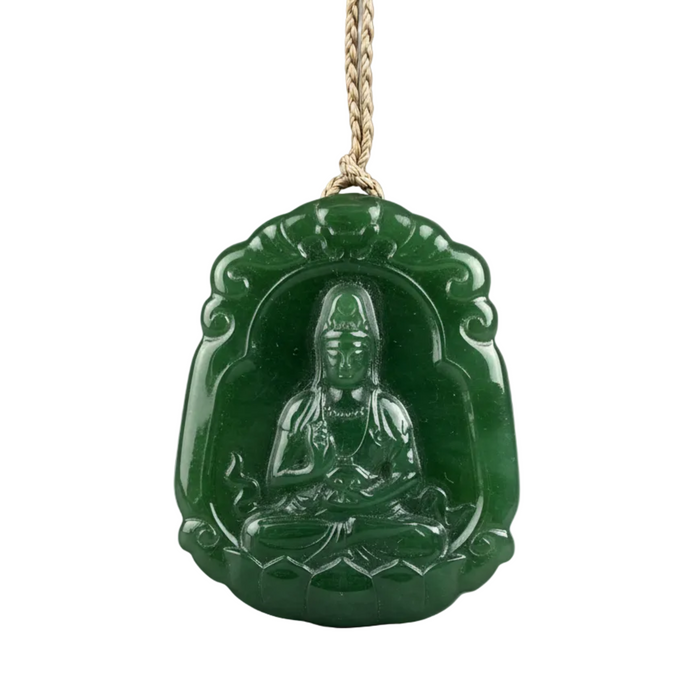 Green jade pendant with Kwan Yin figure on a white background