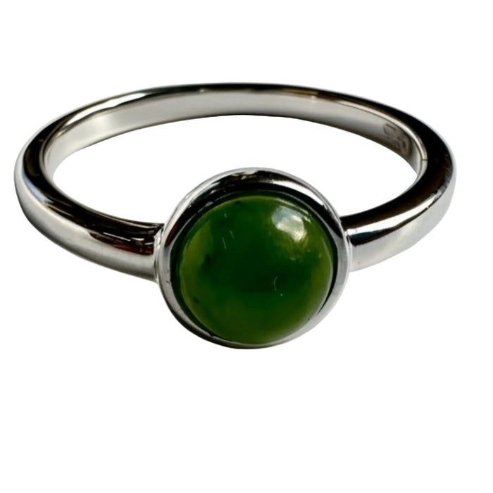 Silver ring with a green jade gemstone on a white background