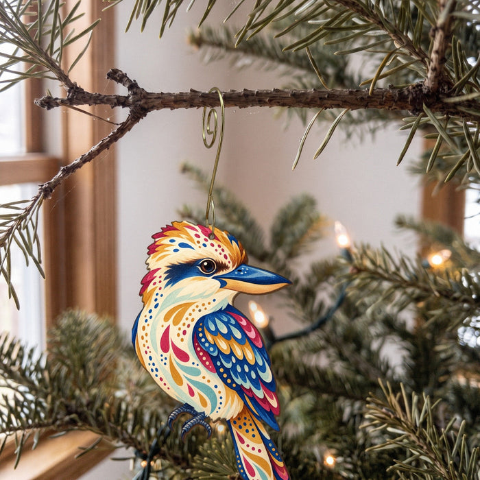 Laser-cut maple wood Kookaburra folk art ornament O525 hanging on a fir branch, made in USA