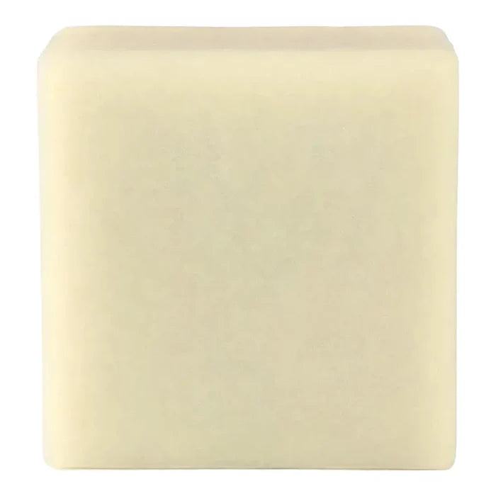 A single square bar of pale cream-coloured soap against a plain white background.