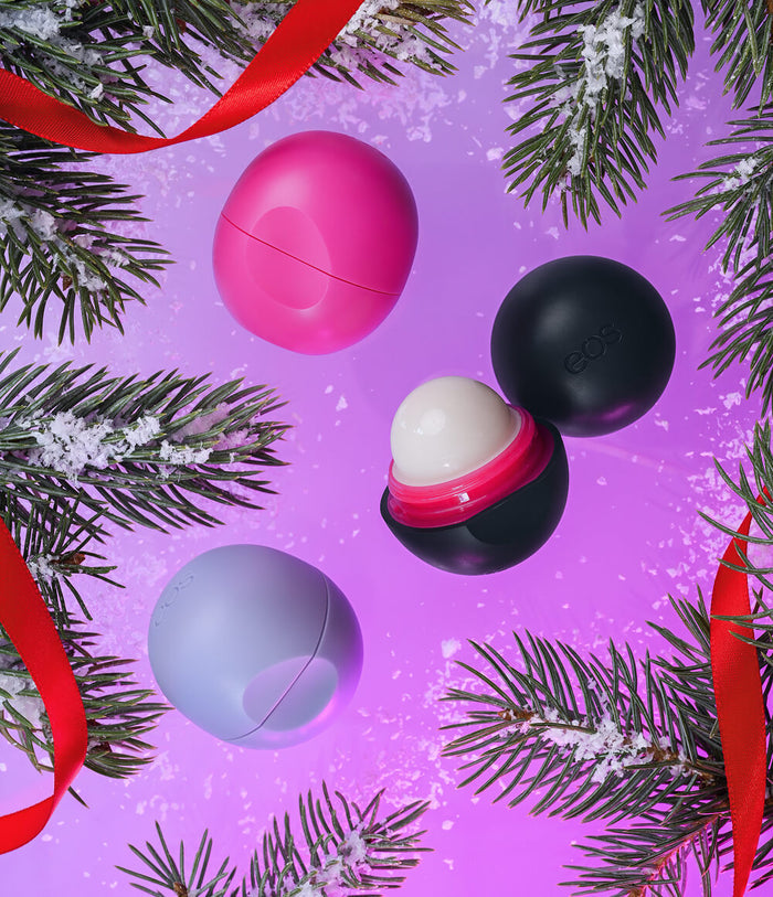 three lip balms on a holiday background