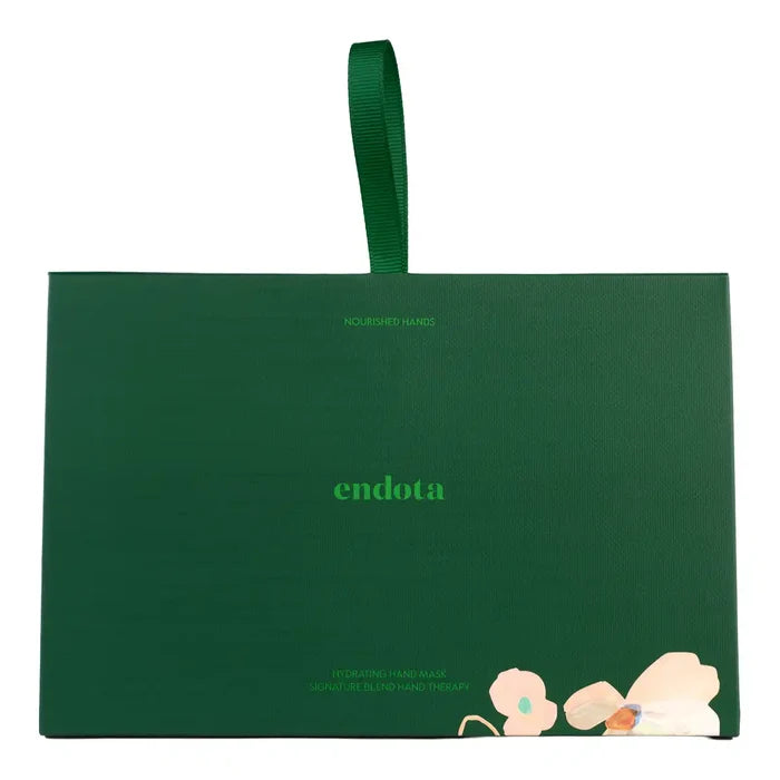 A dark green rectangular product box with a matching green ribbon handle, featuring the brand name 'endota' in light green text and a small floral illustration near the bottom right corner, set against a plain white background.