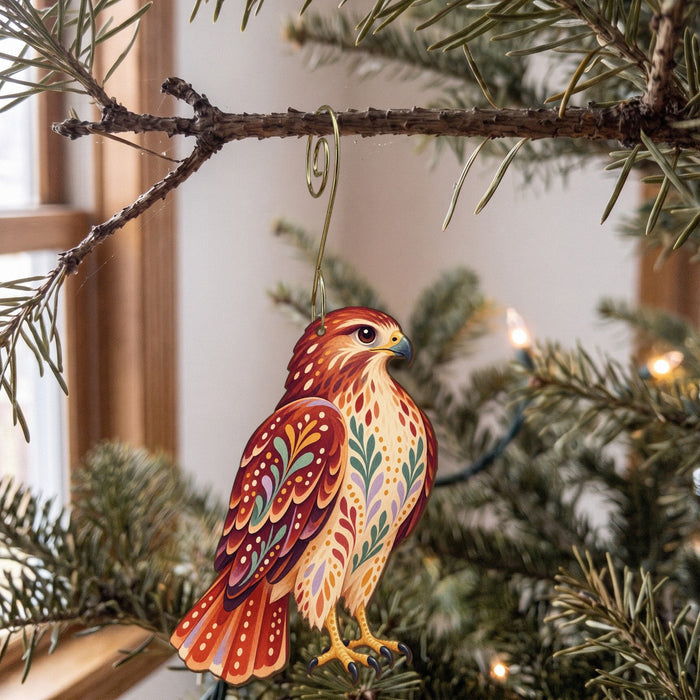 Laser-cut maple wood Red-Tailed Hawk folk art ornament O294 hanging on a fir branch, made in USA