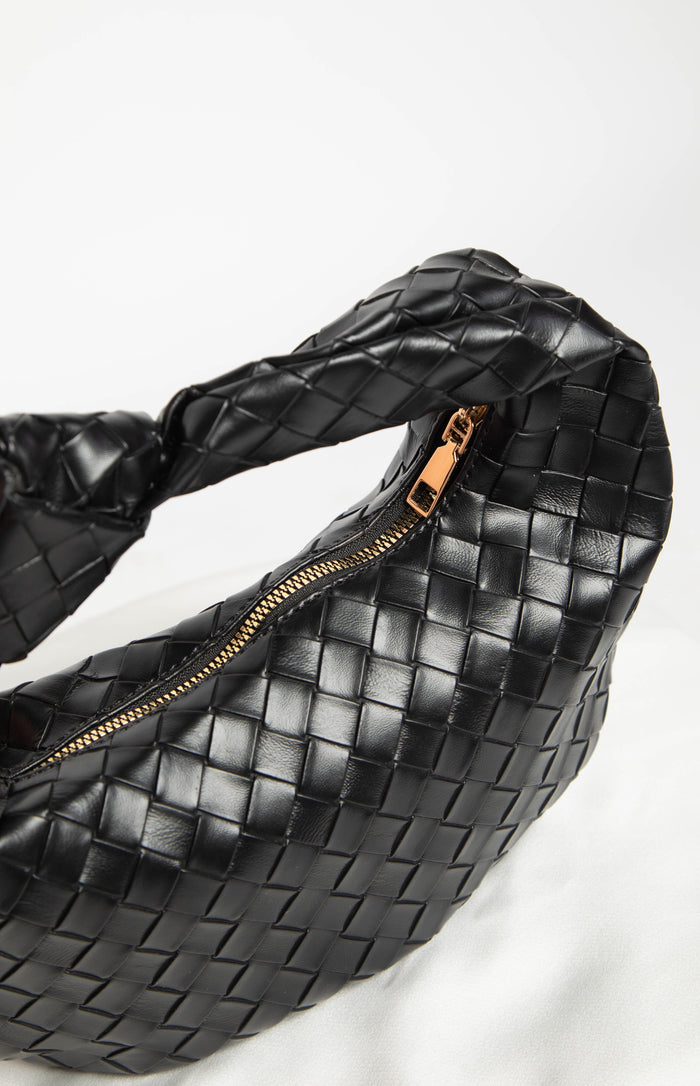 Close-up of the black woven PU shoulder bag showing the gold-toned zipper and textured material