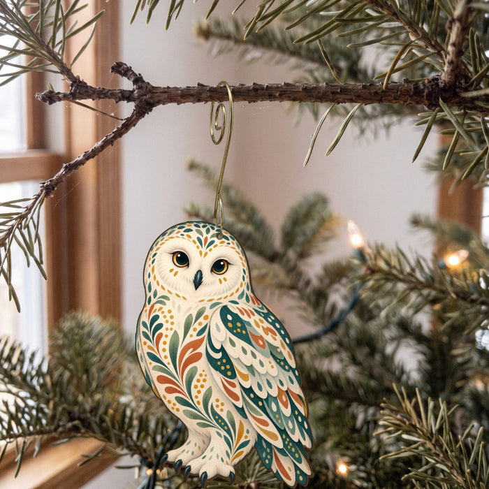 Laser-cut maple wood Snowy Owl folk art ornament O299 hanging on a fir branch, made in USA
