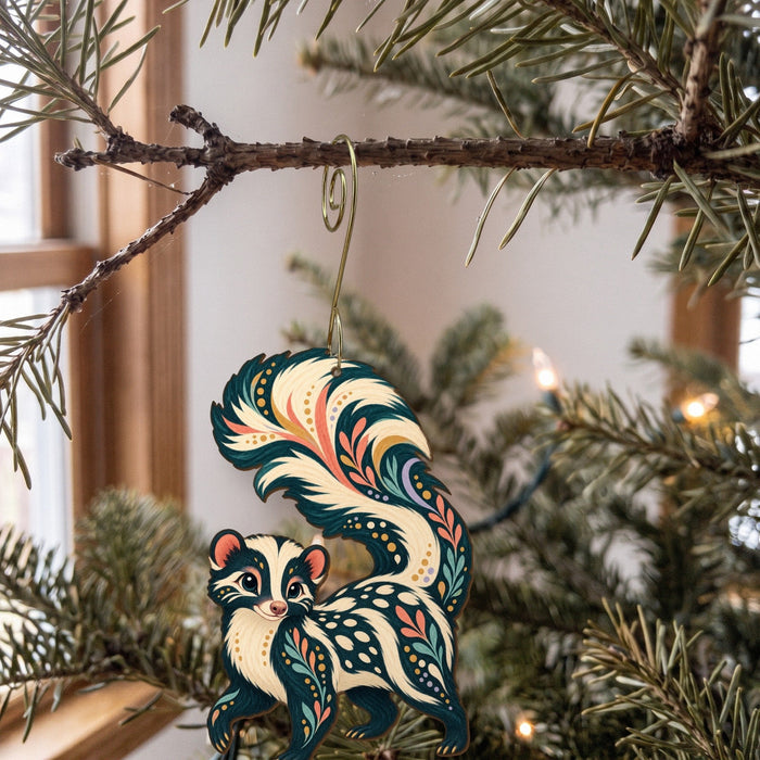 Laser-cut maple wood Spotted Skunk folk art ornament O271 hanging on a fir branch, made in USA