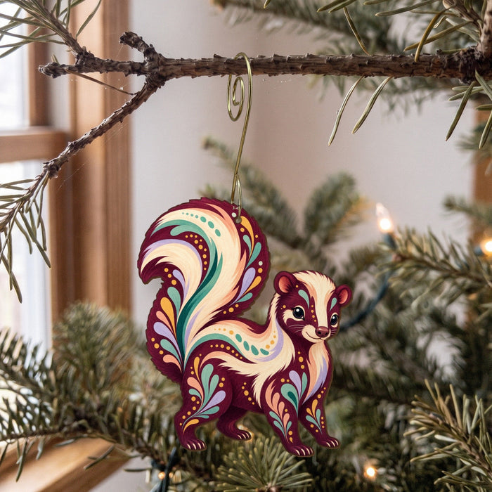 Laser-cut maple wood Striped Skunk folk art ornament O270 hanging on a fir branch, made in USA